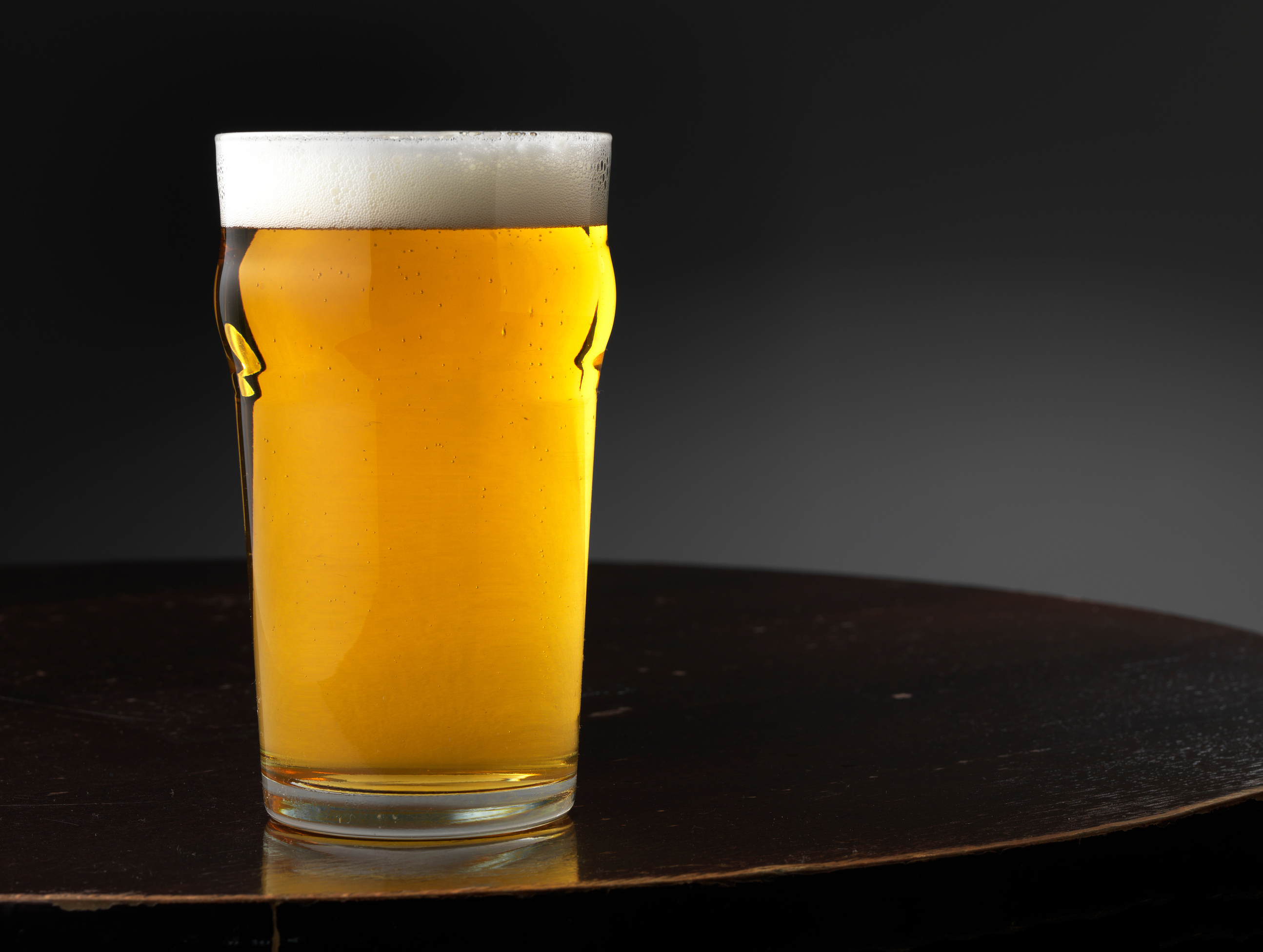 Pint of beer on pub tabletop